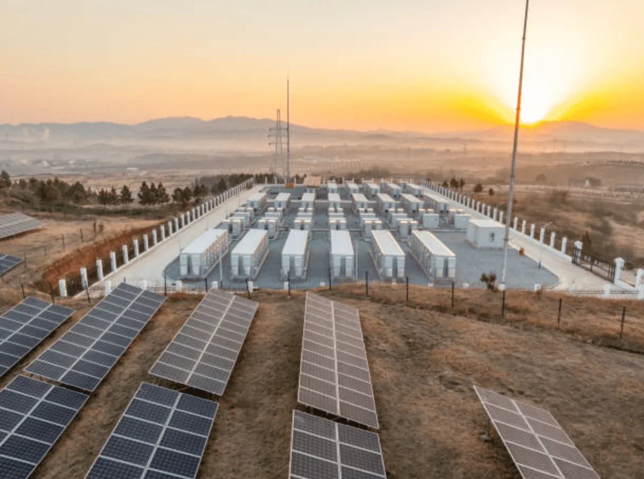 A wall-mounted home battery unit beside a solar array